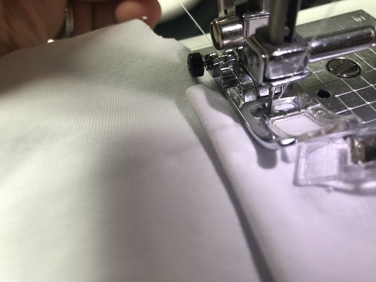 It's also easiest to keep the fabric moving by grabbing onto the fabric behind it or holding on to the top and bottom thread and tugging lightly.