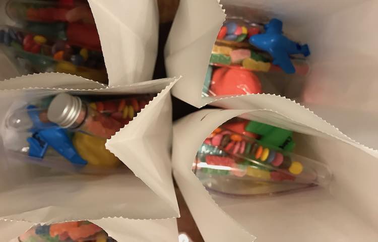 And then bagged them all up. The morning of the party I laid them out above the kids reach and put their party hat overtop of their matching bag. I forgot to hand out the hats so they ended up being good-bye hats on the way to the door.