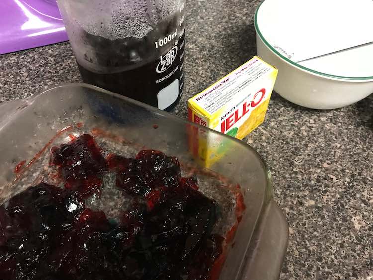 Like before I broke up the red in the casserole dish, moved half into the beaker, and mixed up some yellow Jello.