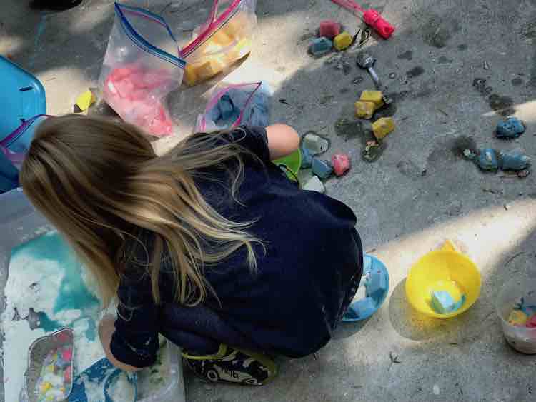 Ada playing in the vinegar and oobleck sensory bin.