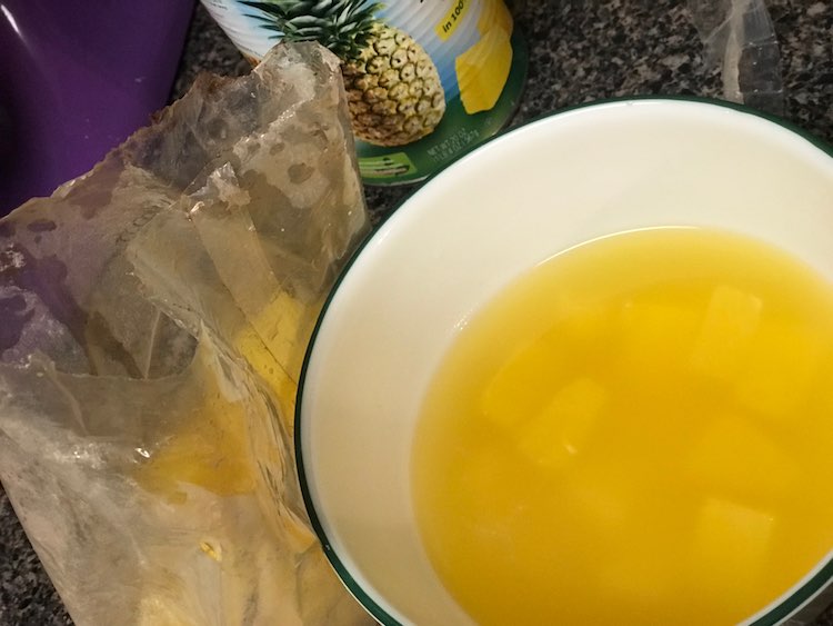 Separated the canned pineapple by moving two thirds of the chunky pineapple to another dish (brownie mix bag).