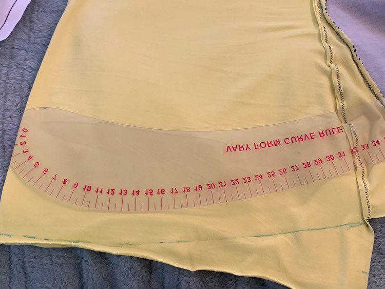 I then took one of my rulers and drew a curve down from the side seam before adding a straight line to the center fold. The ruler is backwards and upside down but it's labelled 'Vary Form Curve Rule'.