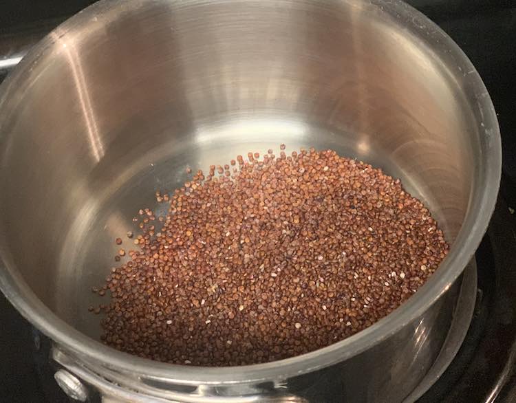 The cookbook I was following had you start by toasting your quinoa. I added the required amount of red (pumpkin colored) quinoa to slightly heated pot.