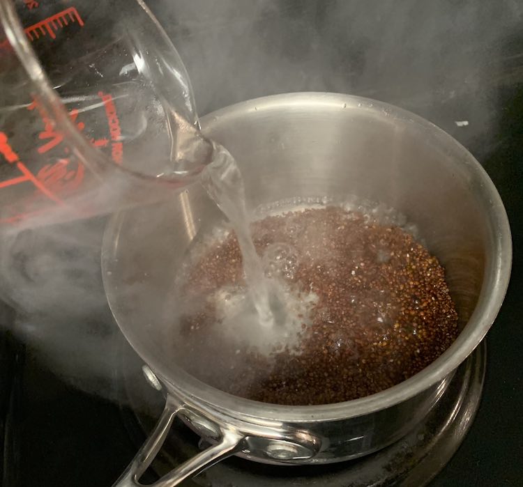 I had set aside the required amount of water ahead of time so once the quinoa was toasted I was able to quickly add the water. It immediately came to a boil so I turned down the heat and covered the quinoa to simmer.