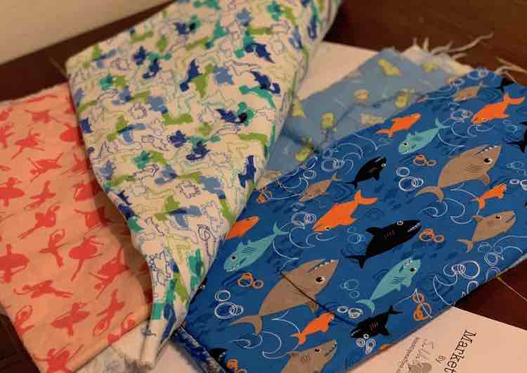 The outer and lining comes in two pieces so the kids got to pick two fabrics each so half would be one and the other half the other. Zoey went with ballet and dinosaur fabric while Ada choose sleepy dinosaurs and sharks. All fabrics had been bought from JOANN Fabrics with three of them thin fuzzy flannel and the sharks with no fuzz.