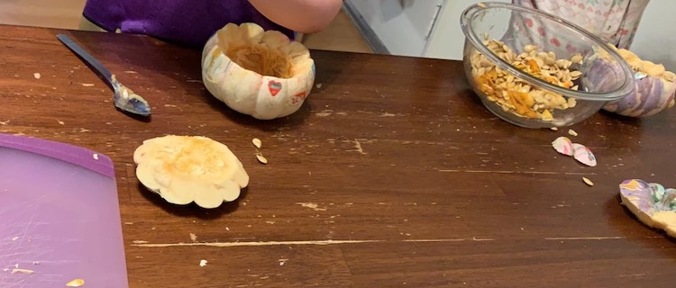 Removing the pumpkin guts into the provided 'garbage' bowl. If the pumpkins hadn't been painted I would've had them seperate the seeds out to bake with cinnamon and sugar.