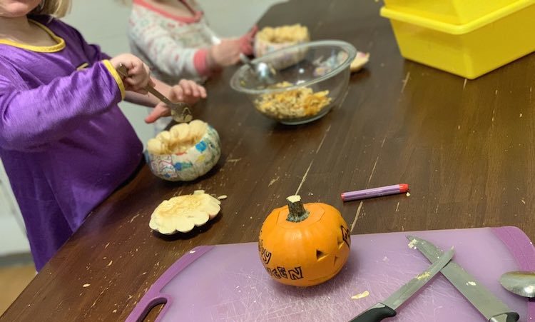 We started by cutting the tops off of the pumpkins (me), and then using grapefruit spoons and our fingers to pull out the guts. I carved a small and simple face on my pumpkin and gave Ada a crayon to mark hers. I ended up cutting a simple heart on Ada's and left Zoey's plain as I realized the solution might spill out from the cut holes before it could be mixed.
