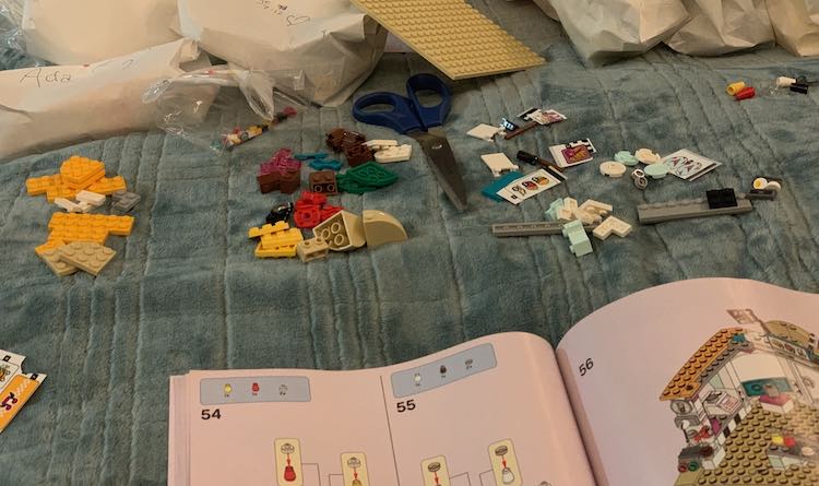 The third package was divided where my scissors are and I checked the book for the page numbers. I then wrote the corresponding page numbers on those two bags and bagged the LEGO bricks.
