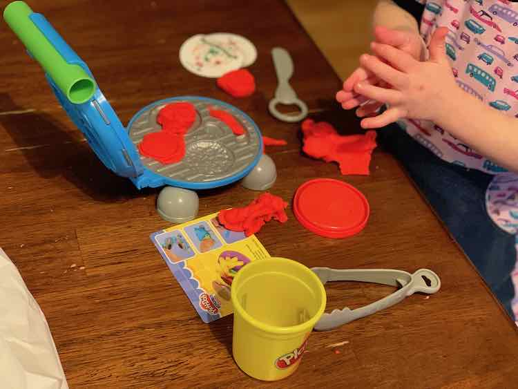 Zoey was loving the barbecue set and red Play-Doh and only noticed the LEGO later on.