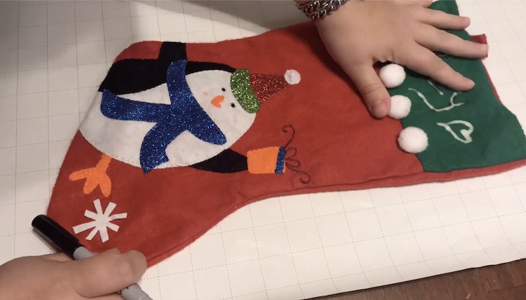 I started by making a pattern piece for my main stocking. I used a Dollar Tree stocking I bought before as my template and used wrapping paper I had on hand for a sturdy template.