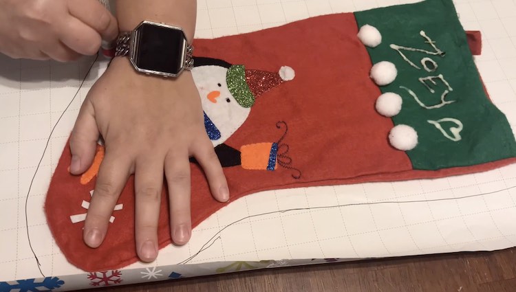 I held two pens while tracing around the stocking. The one pen drew while the other pen was used as a spacer so the line would be further away from the stocking. I wanted a slightly larger stocking and wasn't sure how much space I'd need for seam allowance.