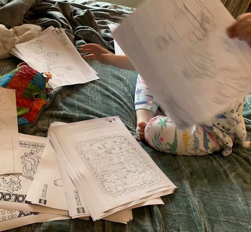 Ada separating the printed coloring pages into an Ada pile and a Zoey pile.