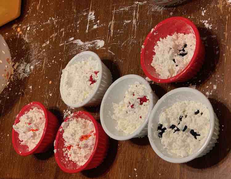 Small containers of cornstarch and water-based food dye.