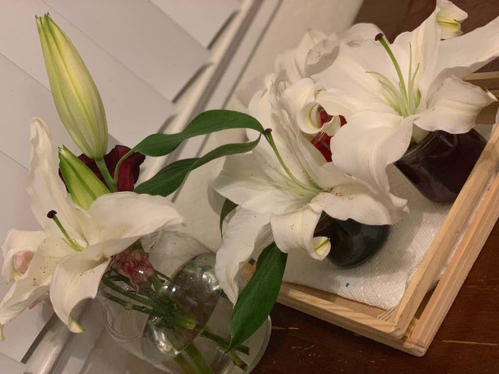 White lilies in their own respective vases.