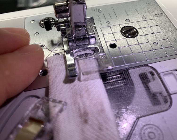 Sew your strap closed while keeping the thread out of the way.