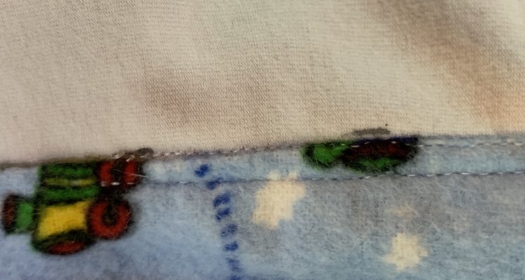 Two lines of stitches with one going off the liner.