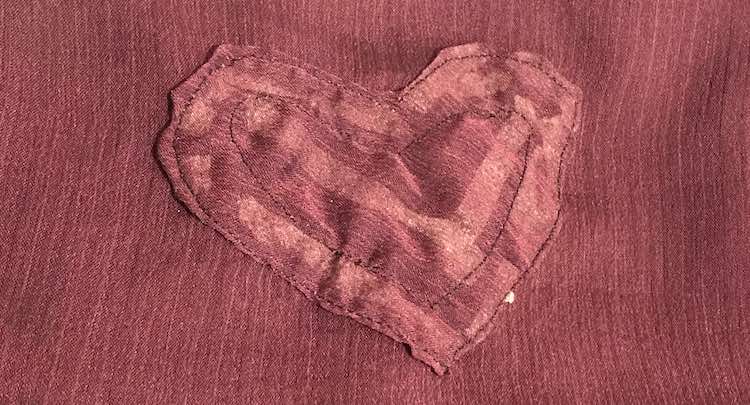 Front of the heart on the camisole after it was sewn on. You can see the tape behind the heart. 
