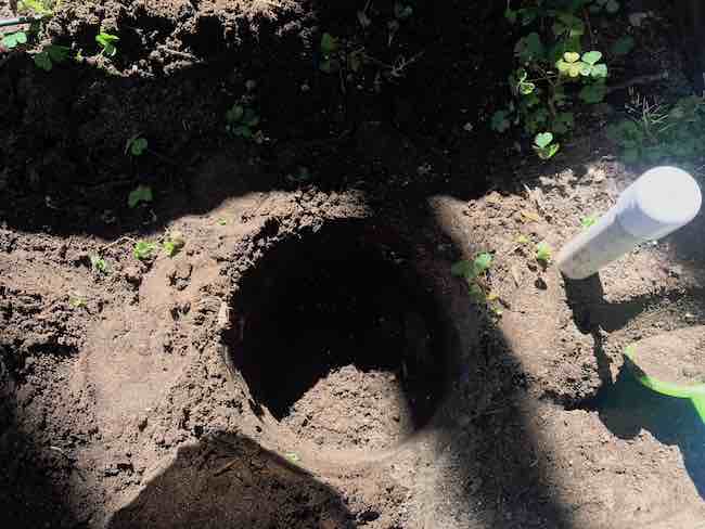 Empty hole perfectly shaped to the bucket.