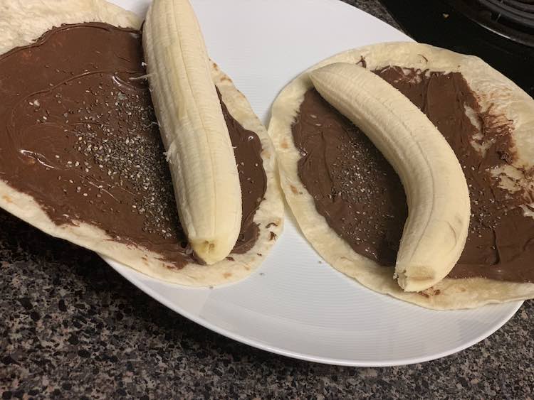 Tortilla, Nutella, chia seeds, and a banana all ready to be rolled.