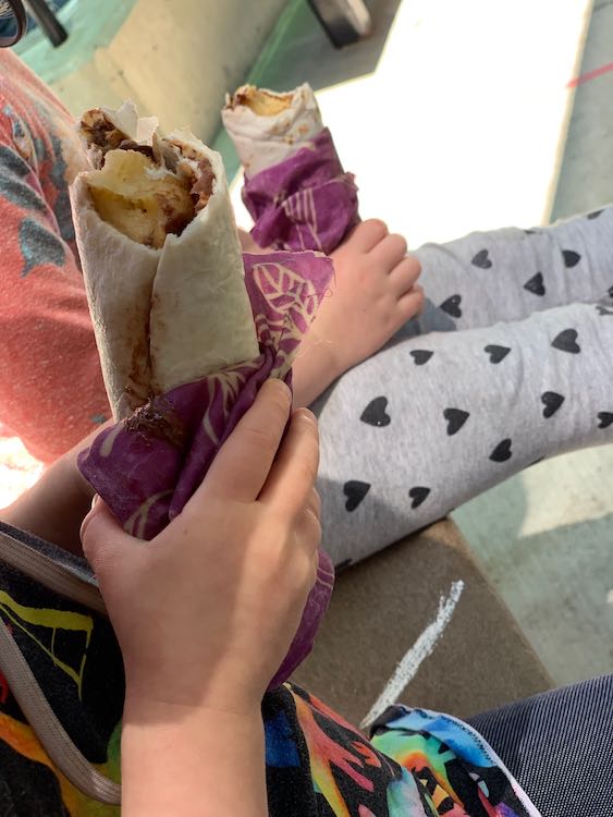 Kids holding the beeswax wrapped Nutella banana wraps.