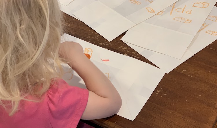 Zoey coloring the favor bags.