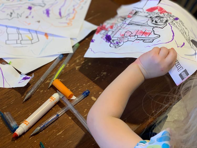 Zoey cutting out her coloring page.