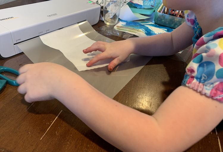 Ada feeding a sheet into the laminator.