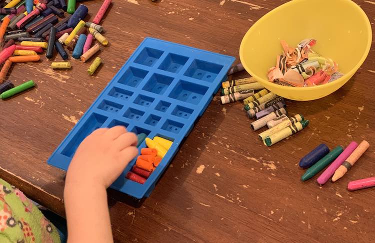 Yellow to orange to red crayon brick filled in while Zoey starts filling the brick mould next to it.