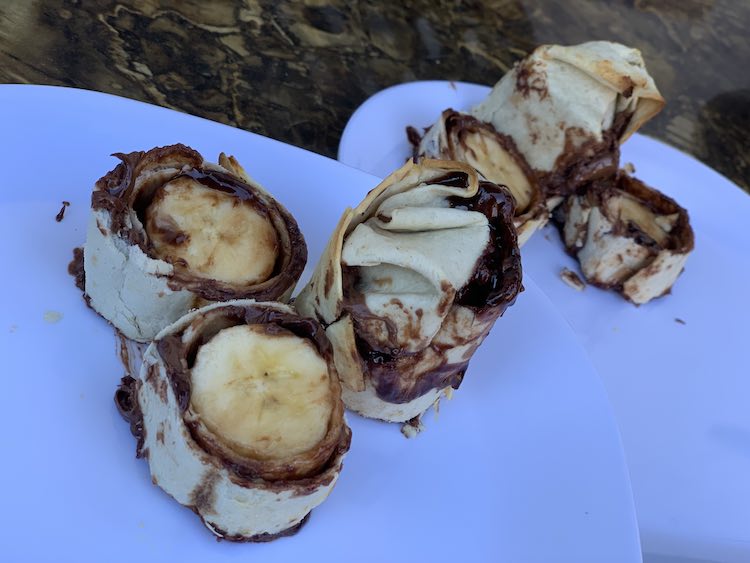 Plated sliced barbecued banana wrap.