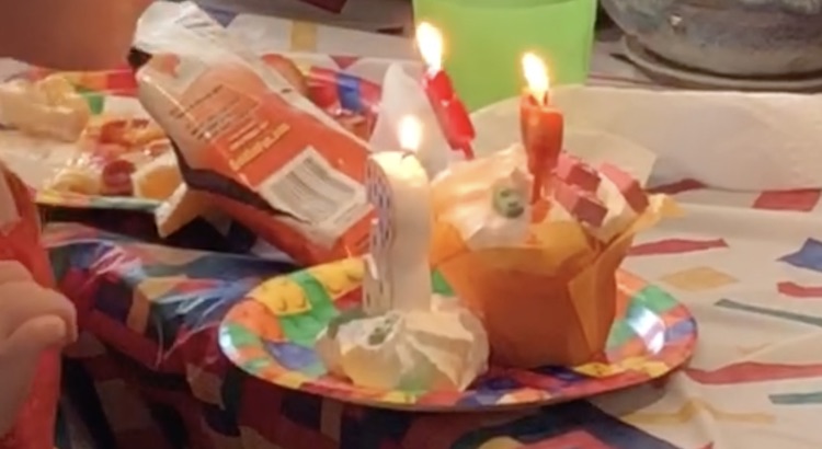 Zoey about to blow out her candles on her birthday cupcake.