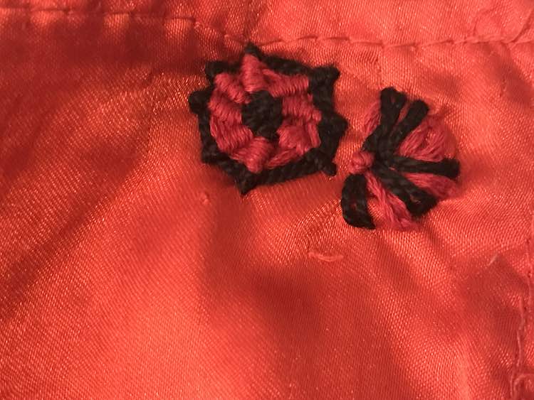 The finished whipped spider stitch and half lazy daisy flower with french knots.