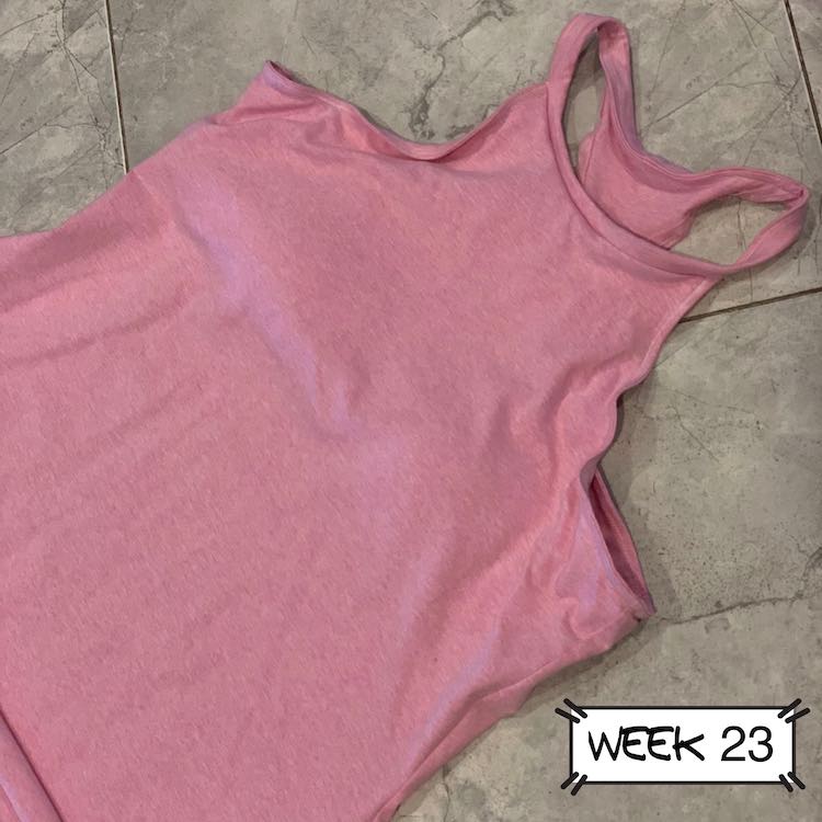Closeup view of the upper portion of the new shirt laid out on the floor.