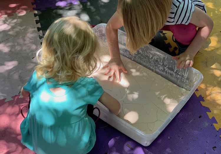 Kids touching the dried oobleck.