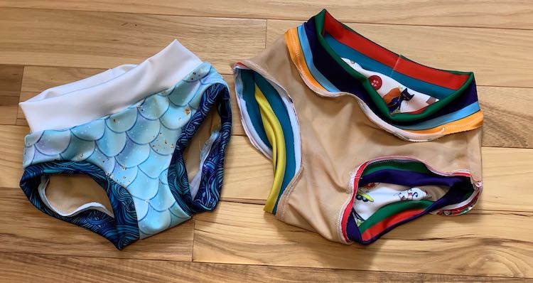 View of both the swim bottoms. The one on the left is right side out and the ones on the right are inside out showing the lining. 