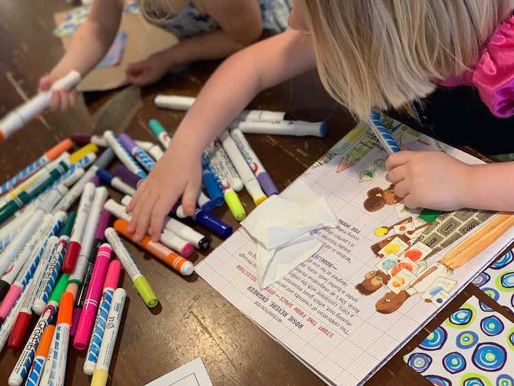 Ada and Zoey reaching for the fabric markers.