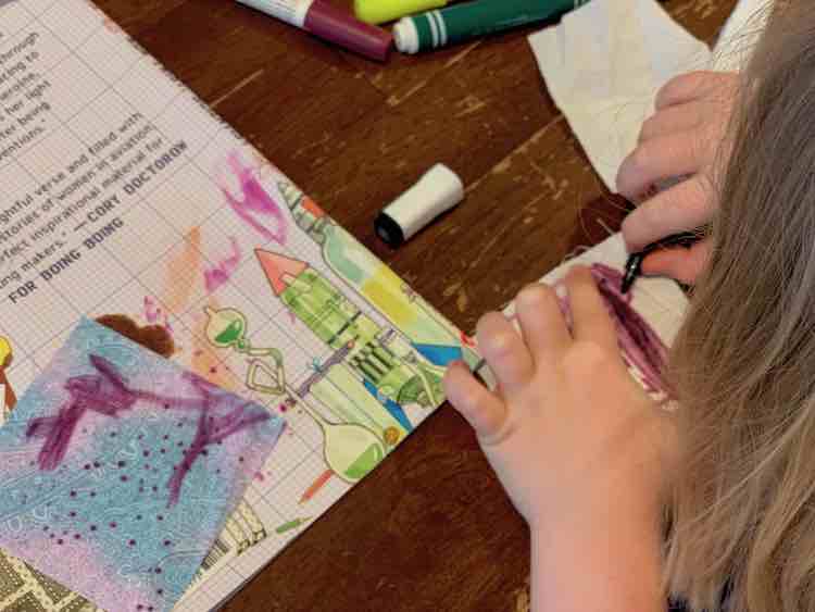 Ada coloring her masterpieces.