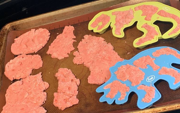 Some of the dinosaur fossils laid out on a cookie sheet ready to go in the oven.