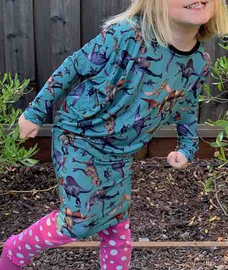 Ada posing by leaning forward and making fists. Dress matched with pink pants with white polka dots.