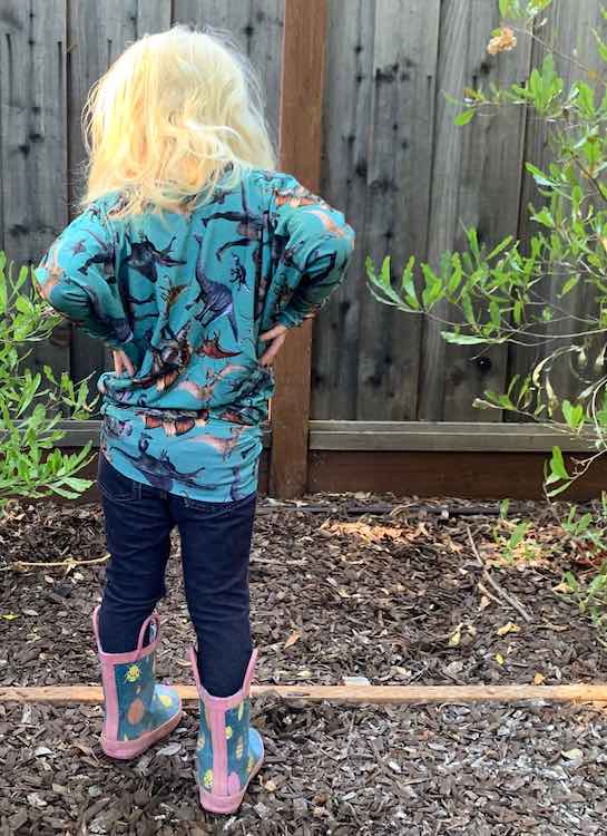 Back of the 'shirt'. Zoey has hands on hip, jeggings on, and insect rubber boots.