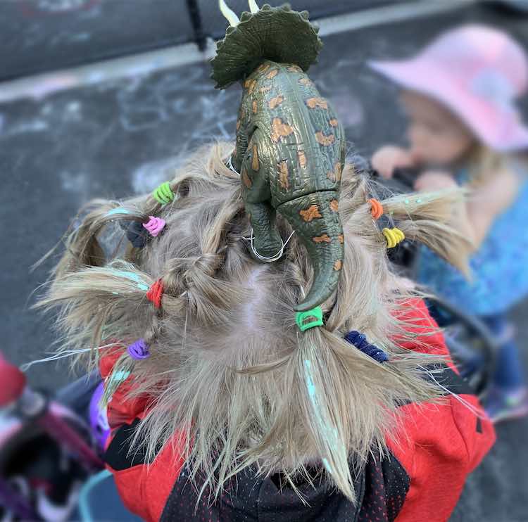 Closeup of the top of the dinosaur and the top view of Ada's crazy hair. The hair gel is still, mostly, in place after a day at school.