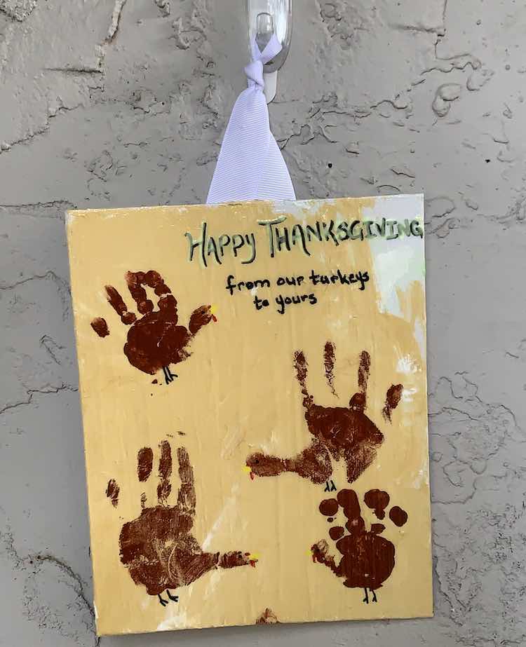 The "Happy Thanksgiving from our turkeys to yours" sign is hung up and showing off the girls little hand prints. 