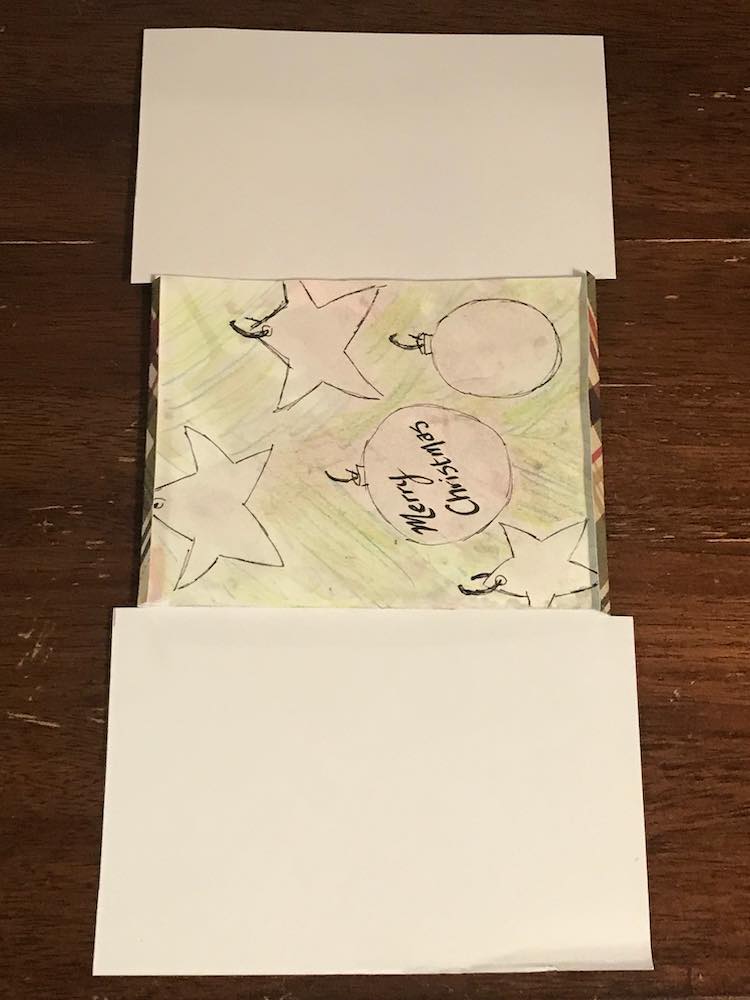 Long rectangular piece of cardstock with the middle folded around the edges of the card. The bottom part is almost as tall as the card while the top part is shorter than the width of the card. 