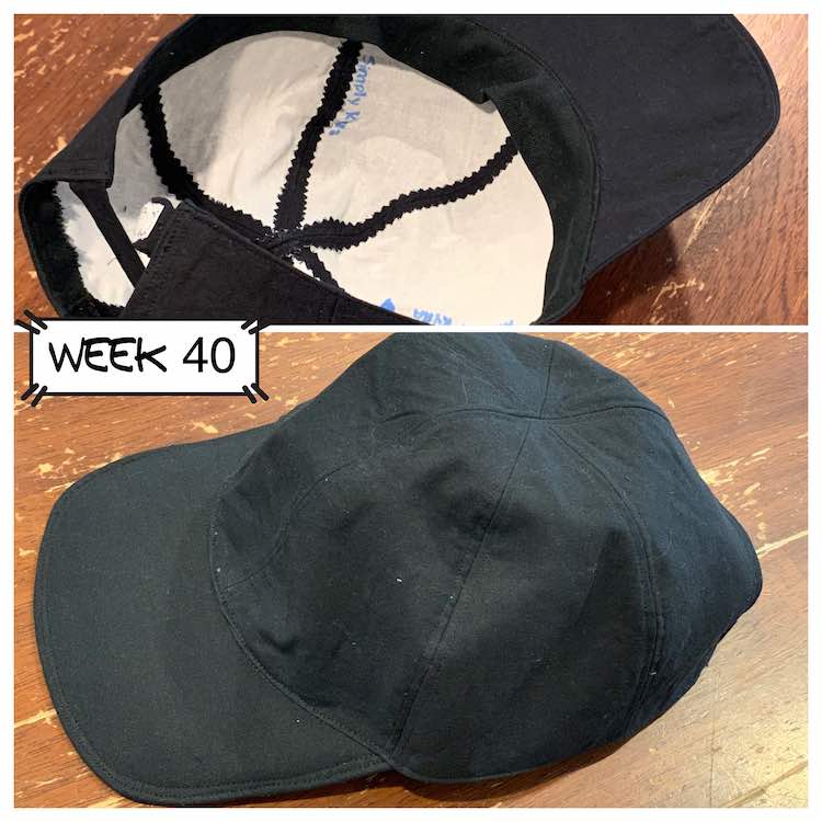Two views of the finished back baseball cap. The outside is all black and the white inferfacing is showing on the inside. Top image is upside down showing the inside and the bottom image is right side up.