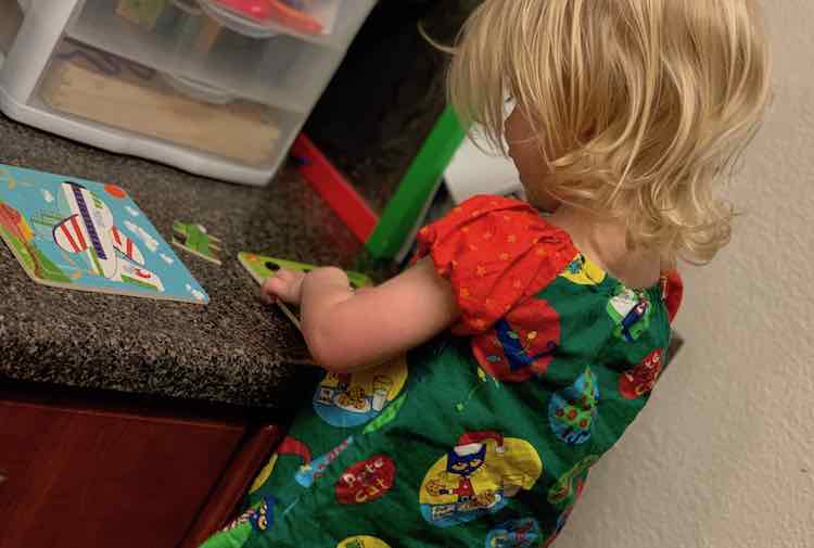 Back view of Zoey and front view of the closed drawers. You can see Zoey playing with her puzzles. 