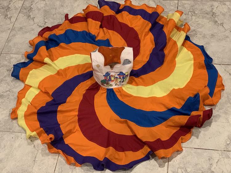 Zoey's dress laid out on the floor. The front of the bodice is shown, along with the back of the lining, as the bodice has been set upright. Around the bodice the skirt is spread out into a fluttery circle.