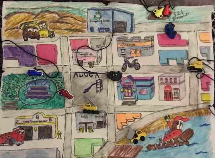 Ada's quiet book page after the buttons were added. The construction vehicles and a car were attached with fishing line while the rest were attached with embroidery floss. The rocket ships are gathered at the top right of the page so they could blast off from the launch pad.