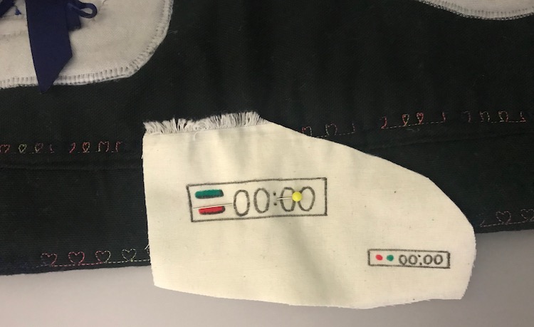 The timer fabric was cut out including both the timers still attached. The scrap of fabric was pinned to the front flap over the large timer and centered vertically.
