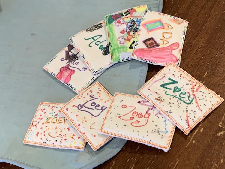 All eight name tags fanned out to see. The bottom shows Zoey's name tags and they're spread out enough to see most of them. The top half shows Ada's, more overlapping, name tags.