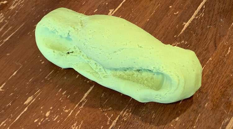 The playdough is now a shorter, than the above, cylinder. You can see the grooves in the side where I held the playdough as I pulled. The width, along it's length, is similar all the way so it doesn't show any parts that were about to crumble if I pulled for longer.  