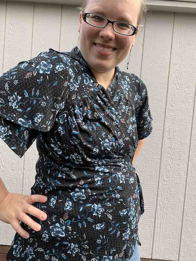 Closeup view of the shirt highlighting where the petal sleeves overlap and the gathering on the front of the bodice.